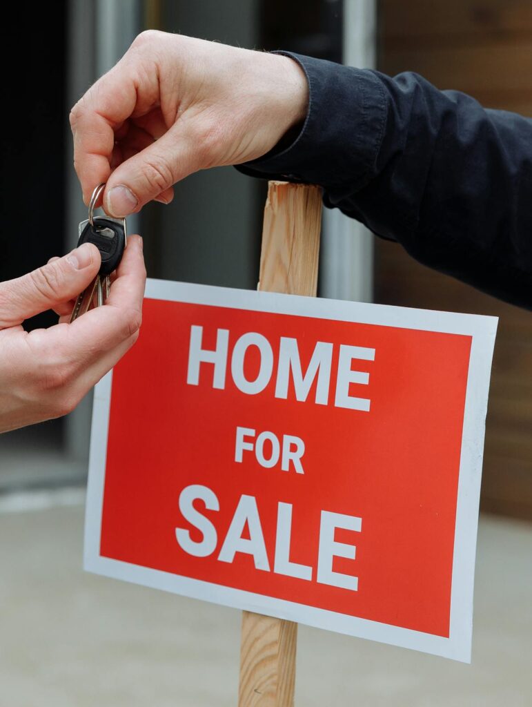 Happy landlord handing over keys to new tenants